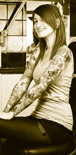 Girl with tattoos on arms in chair